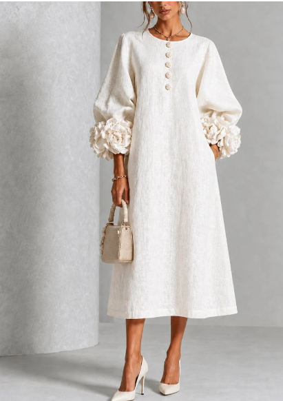 Abito midi abbottonato con stampa floreale e polsini decorati con motivi floreali.